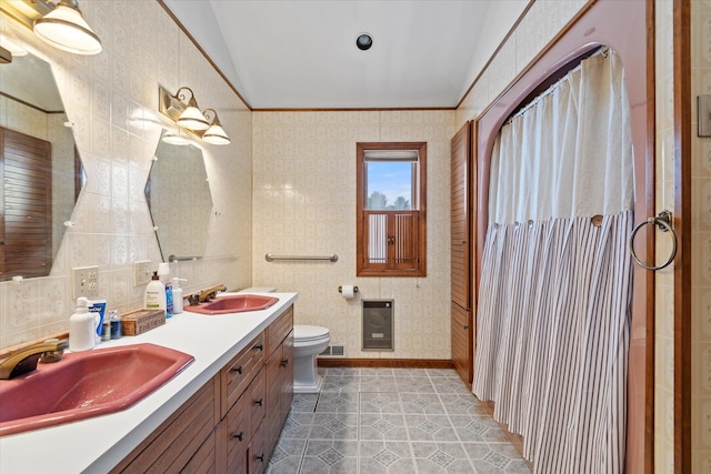 full bath featuring toilet, a shower with shower curtain, a sink, and tile walls