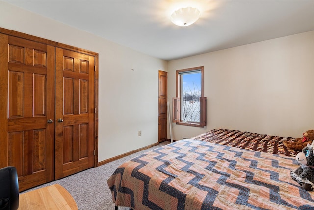 carpeted bedroom featuring baseboards