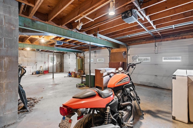 interior space with a garage door opener and water heater