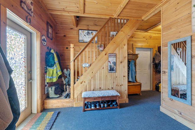 interior space with wooden ceiling, carpet, and wood walls