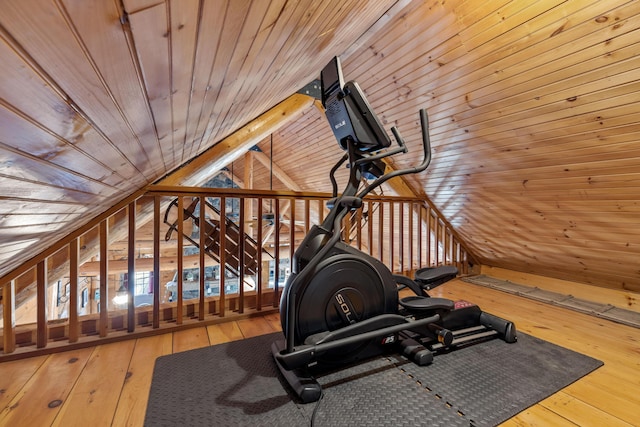 workout room with vaulted ceiling, wood walls, wood ceiling, and hardwood / wood-style floors
