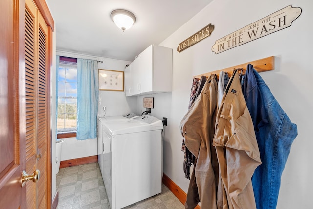 laundry room with independent washer and dryer, cabinet space, light floors, and baseboards