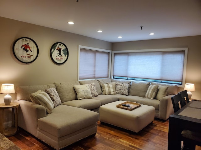 living room with dark wood-type flooring and recessed lighting