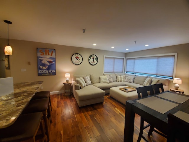 living area with dark wood-style floors, baseboards, and recessed lighting