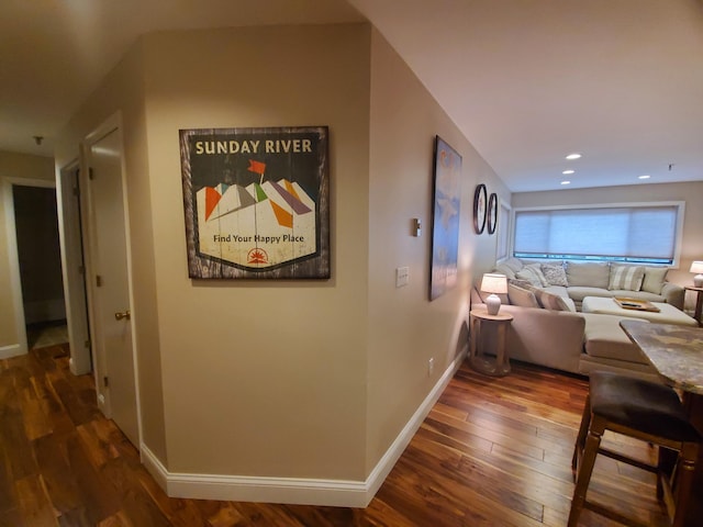 hallway featuring recessed lighting, hardwood / wood-style flooring, and baseboards