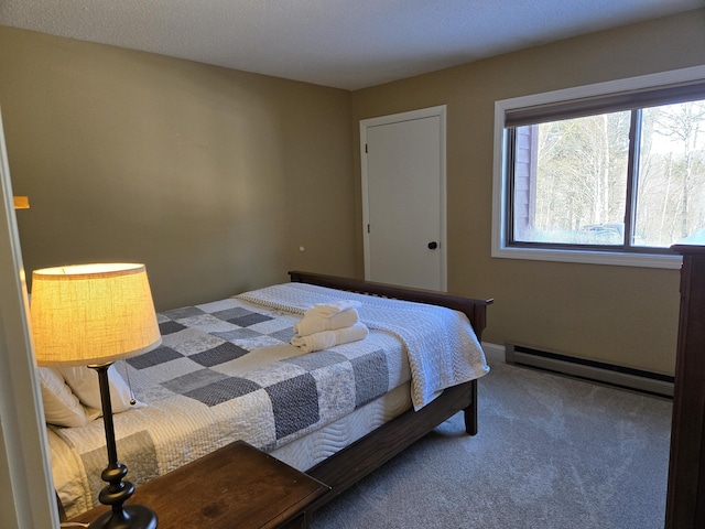 bedroom featuring a baseboard heating unit and carpet flooring