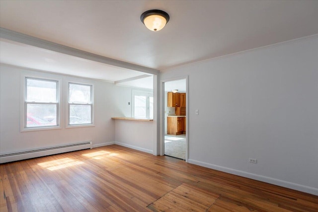 332 Back River Rd, Boothbay, ME 04537 - spare room with wood-type flooring, ornamental molding, baseboards, and baseboard heating
