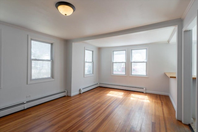 332 Back River Rd, Boothbay, ME 04537 - spare room with a baseboard heating unit, crown molding, hardwood / wood-style flooring, and baseboards