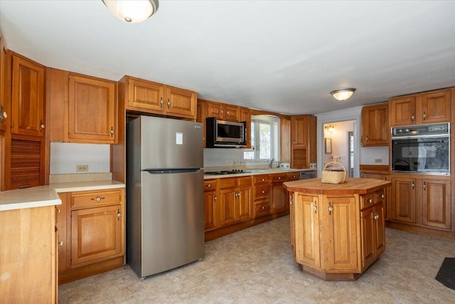 332 Back River Rd, Boothbay, ME 04537 - kitchen featuring black appliances and brown cabinetry
