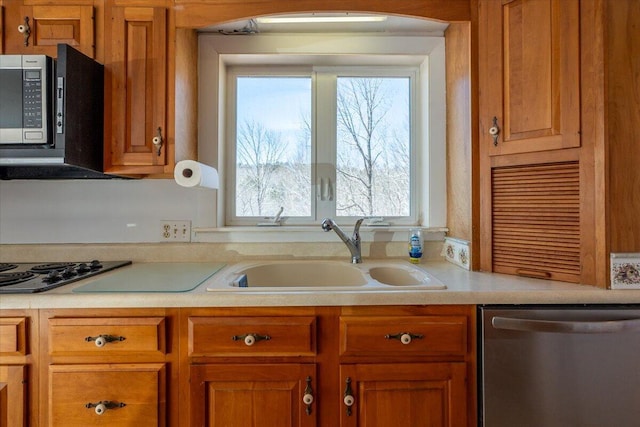 332 Back River Rd, Boothbay, ME 04537 - kitchen with appliances with stainless steel finishes, a sink, light countertops, and brown cabinetry