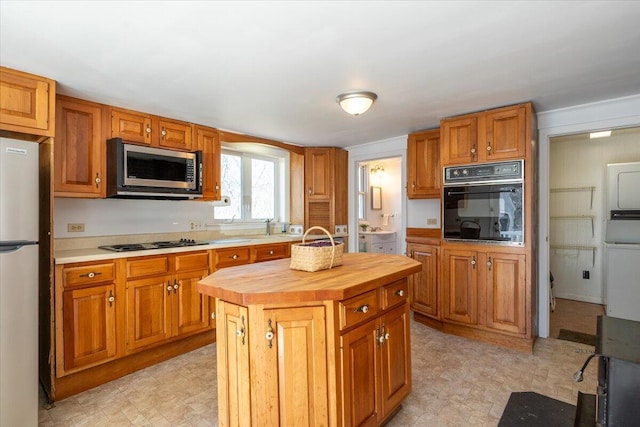 332 Back River Rd, Boothbay, ME 04537 - kitchen featuring black appliances, wooden counters, light flooring, and a center island
