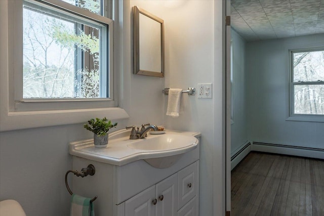 332 Back River Rd, Boothbay, ME 04537 - bathroom featuring vanity, wood finished floors, and a baseboard radiator