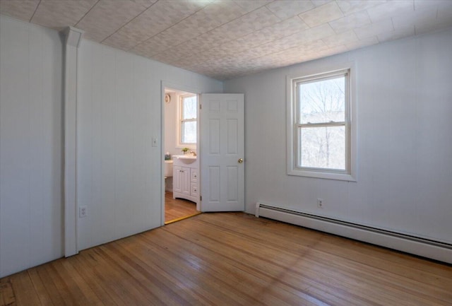 332 Back River Rd, Boothbay, ME 04537 - empty room with wood finished floors, baseboard heating, and plenty of natural light