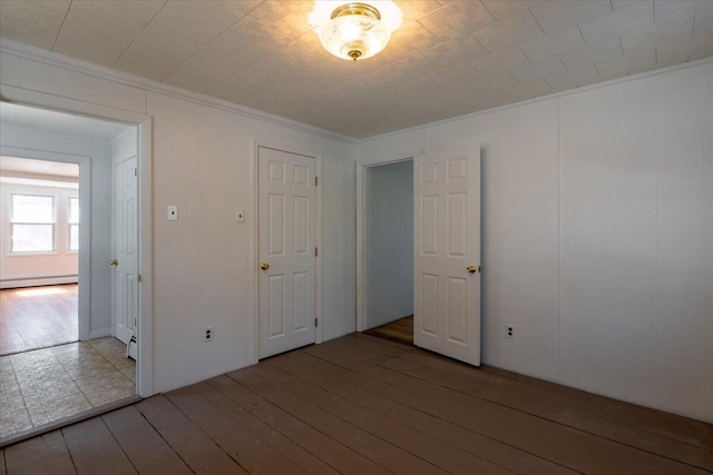 332 Back River Rd, Boothbay, ME 04537 - spare room featuring a baseboard heating unit, wood-type flooring, and ornamental molding