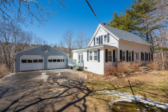 332 Back River Rd, Boothbay, ME 04537 - view of home's exterior with a garage, an outbuilding, and a chimney