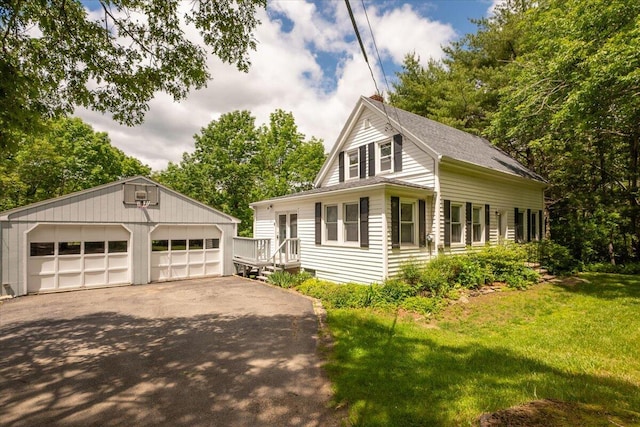 332 Back River Rd, Boothbay, ME 04537 - view of front of home with a detached garage, an outbuilding, a front lawn, and roof with shingles