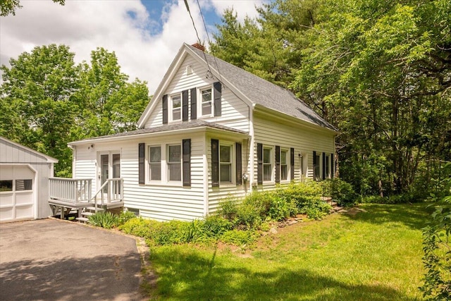 332 Back River Rd, Boothbay, ME 04537 - view of front of property with an outbuilding, driveway, a front yard, a shingled roof, and a garage