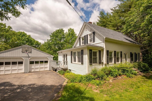 332 Back River Rd, Boothbay, ME 04537 - view of front facade with a chimney, a garage, an outdoor structure, and a shingled roof