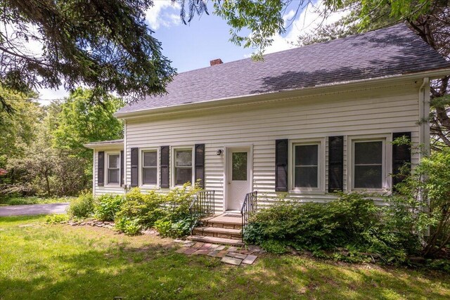 332 Back River Rd, Boothbay, ME 04537 - view of front of home featuring a chimney, a front lawn, and roof with shingles
