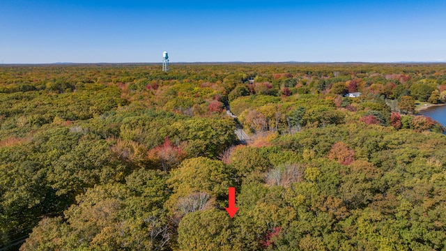 birds eye view of property with a view of trees