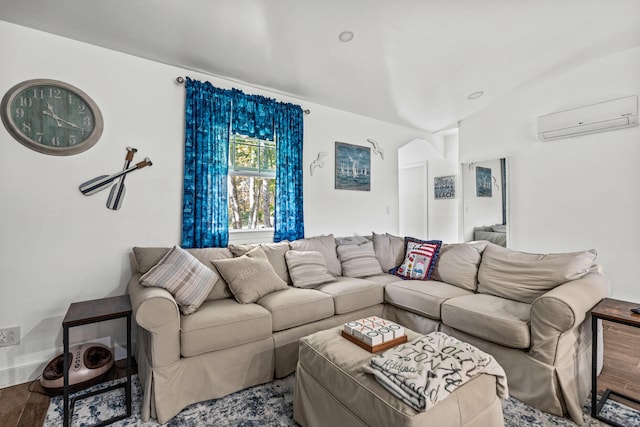 living room with a wall unit AC, wood finished floors, and vaulted ceiling