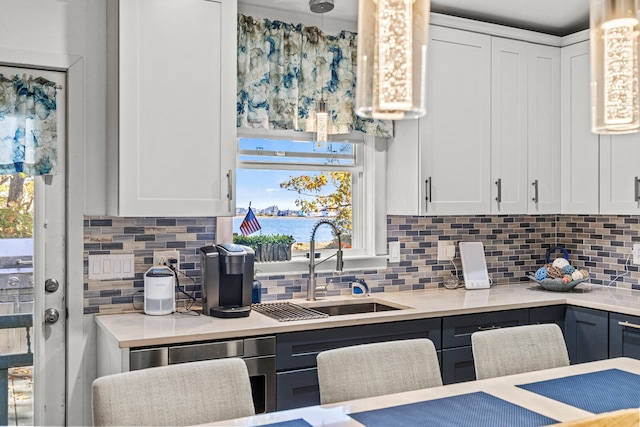 kitchen featuring tasteful backsplash, white cabinets, and light countertops