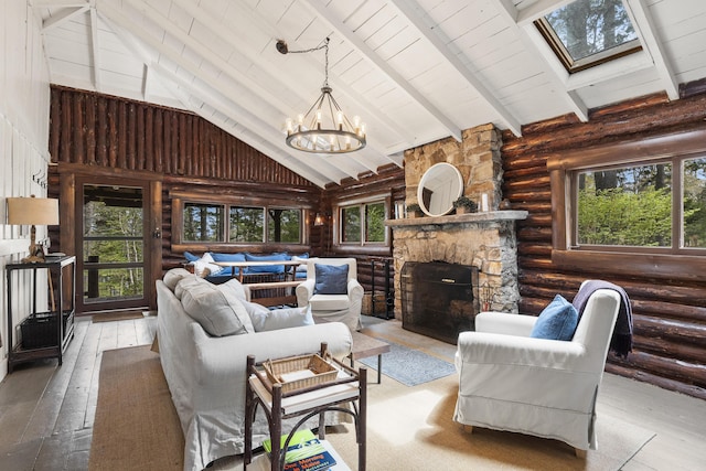 14 Crooked Pine Rd, Boothbay Harbor, ME 04538 - living area with log walls, hardwood / wood-style floors, plenty of natural light, high vaulted ceiling, and a chandelier