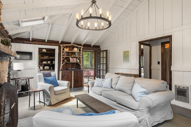 14 Crooked Pine Rd, Boothbay Harbor, ME 04538 - living room featuring heating unit, a chandelier, wood finished floors, wooden walls, and a decorative wall