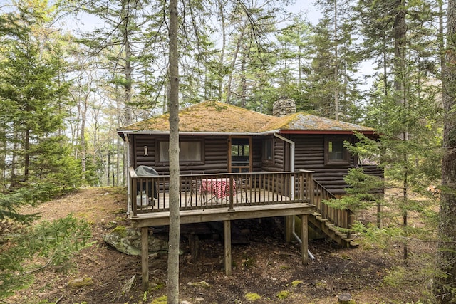 14 Crooked Pine Rd, Boothbay Harbor, ME 04538 - view of front of property featuring log veneer siding, a chimney, a deck, and a shingled roof