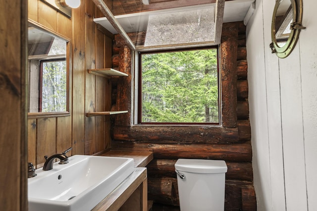 14 Crooked Pine Rd, Boothbay Harbor, ME 04538 - half bathroom with a sink, healthy amount of natural light, toilet, rustic walls, and wood walls