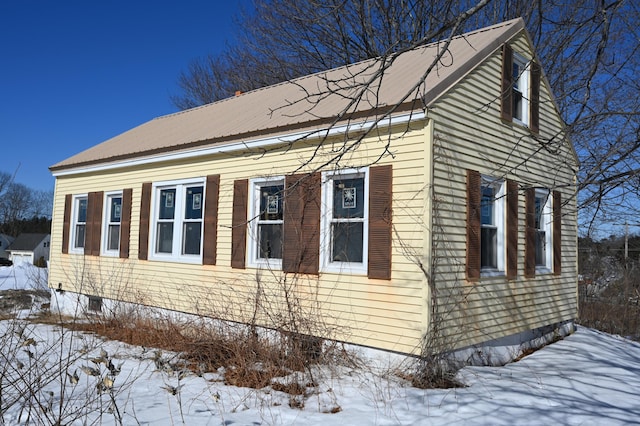 snow covered property with metal roof