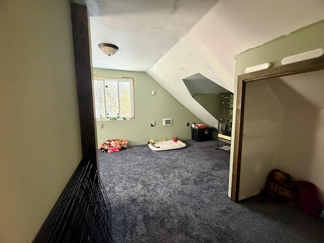 interior space with carpet flooring and vaulted ceiling