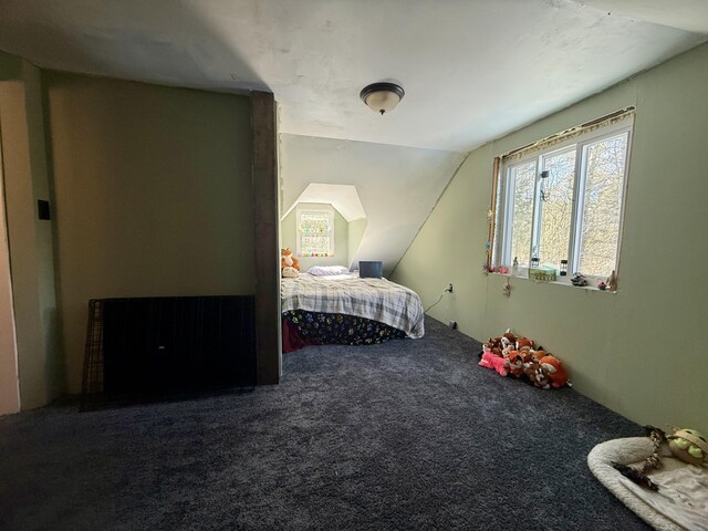 unfurnished bedroom with vaulted ceiling and carpet floors