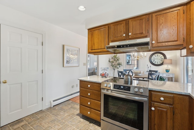 kitchen with under cabinet range hood, a baseboard heating unit, brown cabinetry, and electric stove