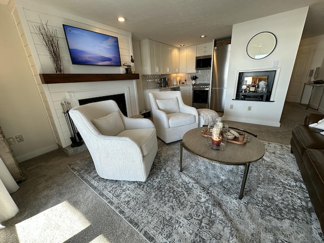 living room with recessed lighting, a fireplace, and baseboards