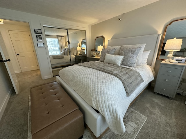 carpeted bedroom with baseboards and a closet