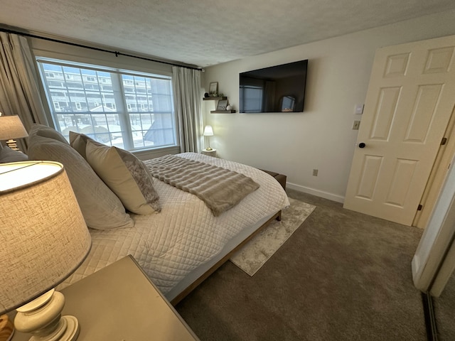 carpeted bedroom with a textured ceiling and baseboards