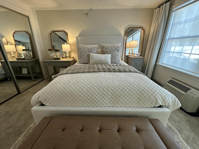 carpeted bedroom with a wall unit AC