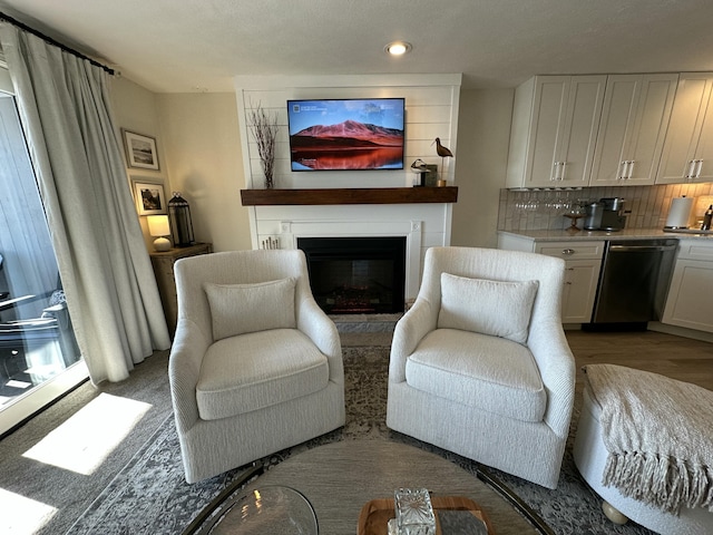 living room with light wood-type flooring and a fireplace