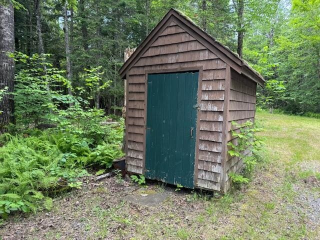 view of shed featuring a view of trees