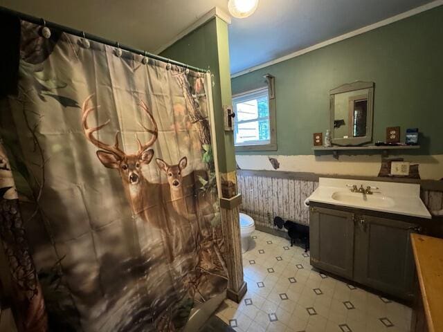 bathroom with crown molding, curtained shower, toilet, vanity, and tile patterned floors