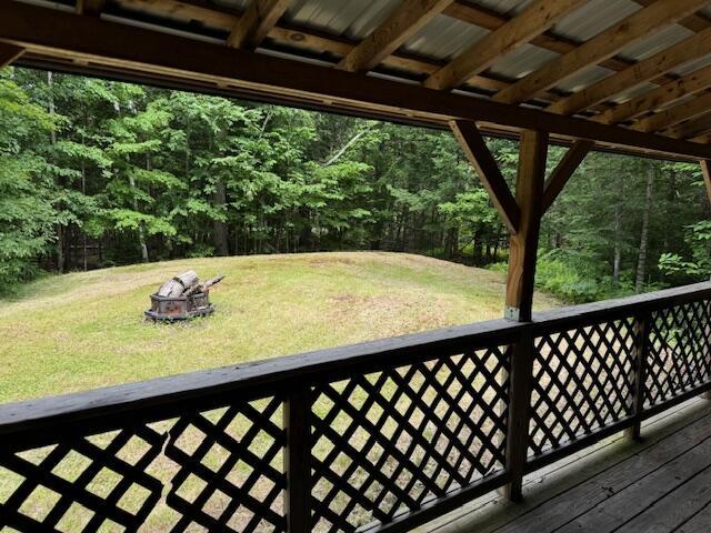 wooden deck featuring a yard