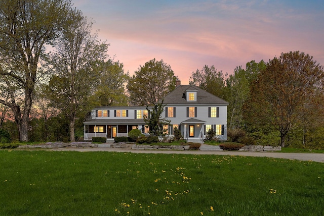 49 Megquier Rd, Gray, ME 04039 - view of front facade featuring covered porch, a front lawn, and a chimney