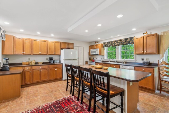 49 Megquier Rd, Gray, ME 04039 - kitchen featuring white appliances, dark countertops, a sink, a kitchen bar, and recessed lighting