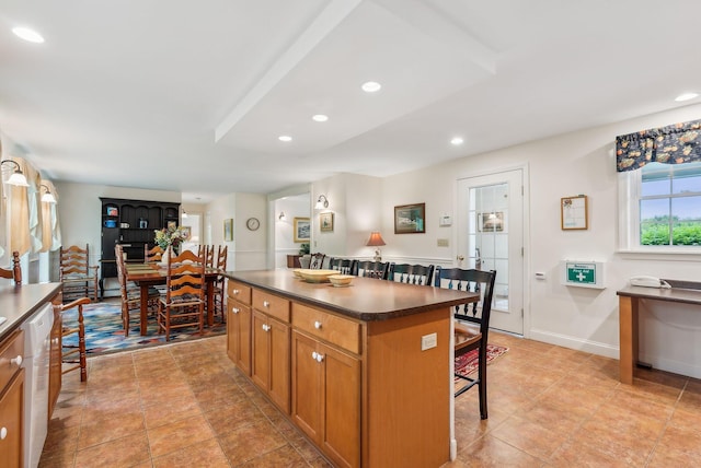 49 Megquier Rd, Gray, ME 04039 - kitchen with a breakfast bar area, dark countertops, brown cabinets, a center island, and recessed lighting