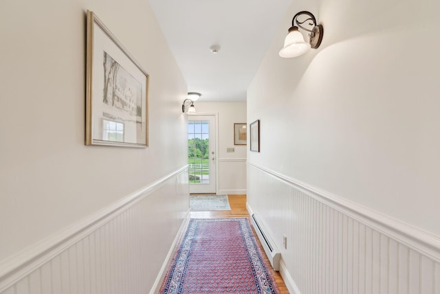 49 Megquier Rd, Gray, ME 04039 - hallway with baseboard heating, a wainscoted wall, and light wood-style flooring