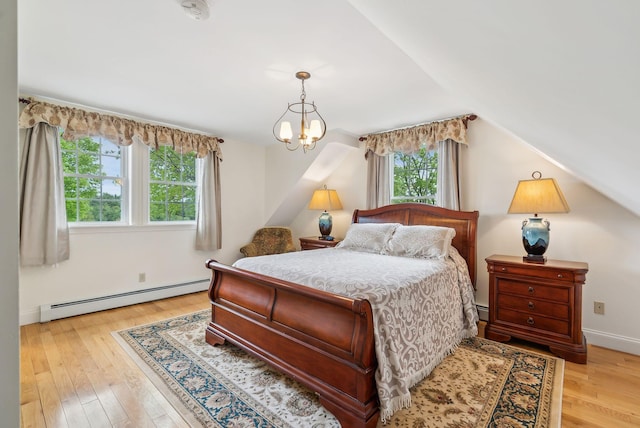 49 Megquier Rd, Gray, ME 04039 - bedroom featuring baseboard heating, light wood-type flooring, a chandelier, vaulted ceiling, and baseboards