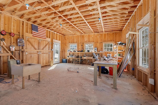 misc room featuring wooden walls and a workshop area