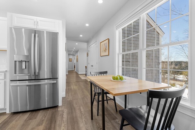 dining area featuring baseboards, wood finished floors, a wealth of natural light, and recessed lighting