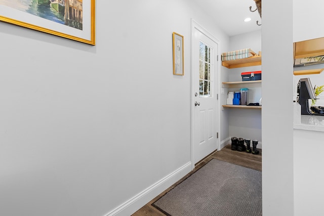 hallway featuring recessed lighting, baseboards, and wood finished floors